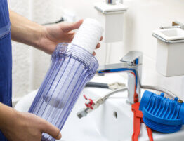 plumber installing new water filtration system