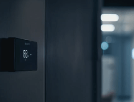 Close-up of a modern thermostat showing temperature, mounted on a wall in a Cuyahoga County home.